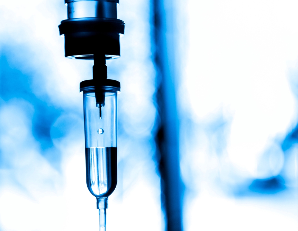 Saline iv bag intravenous drip hospital room,Medical Concept,treatment patient emergency and injection drug infusion care chemotherapy concept.blue light background hospital,Selective focus